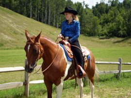 Cowgirl Riding A Horse.