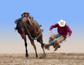 Cowboy bucked of a bucking horse