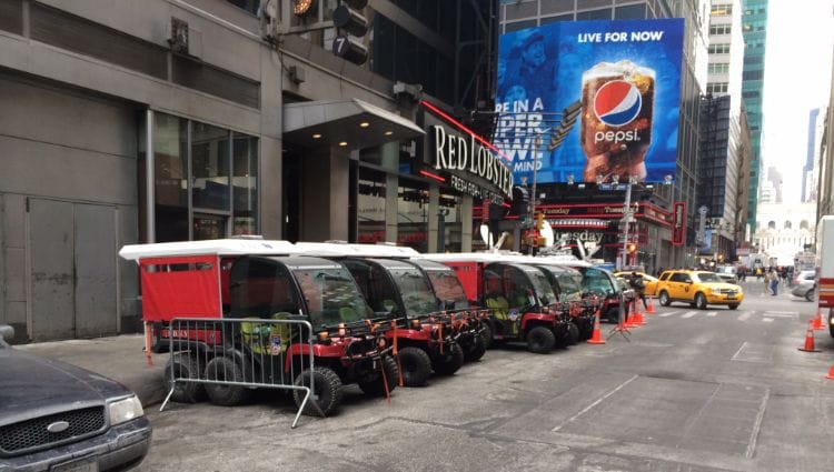 A line of UTVs with skid units outside of a fire department.