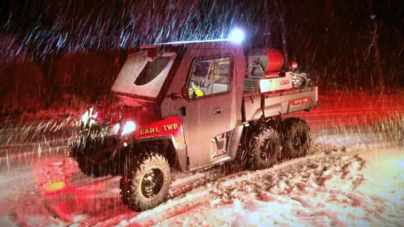 A UTV equipped with a skid unit responding to an emergency in a snowstorm.