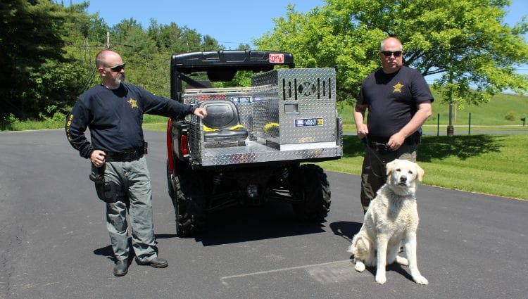 Police officers displaying their new UTV skid unit.