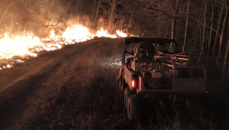 heat-management-overheating-prevention-fire-loaded-atvs Wildfire raging while a fire rescue ATV sits to the side