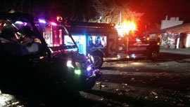 Nighttime fire photo with first responder vehicles.